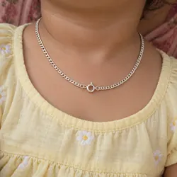 Silver chain worn by a toddler