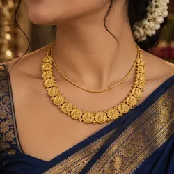 Gold plated coin necklace worn with a silk saree
