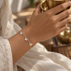 Silver butterfly bracelet worn on the wrist